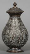 A 19th century Eastern copper and white metal lidded jar
Inlaid with palmettes and deities.  15.5