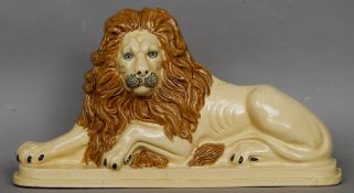 A 19th century Staffordshire pottery lion
Typically modelled in recumbent pose.  58 cms long.