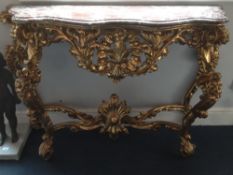 A Florentine marble topped carved giltwood console table
The serpentine shaped top above the