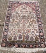 A Persian silk and wool prayer rug
The Mirhab field filled with the tree of life.     CONDITION