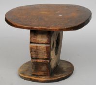 A tribal carved wooden stool, probably African
The top carved with floral motifs above the  main