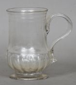 An early 18th century glass tankard
15 cms high.   CONDITION REPORTS:  Generally good, small frit to