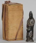 A 19th century Chinese patinated bronze model of Guanyin
Modelled wearing robes holding a basket