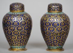 A pair of 19th century enamel decorated brass tea caddies
Each of squat bulbous form with a