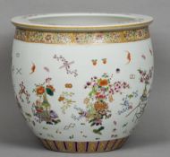 A Chinese porcelain jardiniere
Decorated with vases issuing flowers interspersed with precious