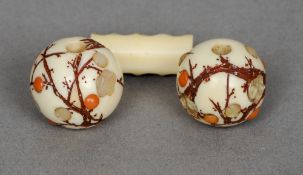 Two 19th century Japanese shibyama inlaid ivory ojime 
Each set with mother-of-pearl and coral.