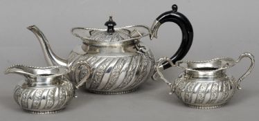 An Indian silver three piece tea set
Decorated with spiral acanthus scrolls, stamped Silver.  The
