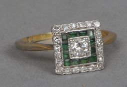 An Art Deco unmarked gold, diamond and emerald ring
Of square form, the central diamond flanked by a