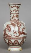 A Chinese porcelain baluster vase
With iron red decoration and twin lion mask handles.  24 cms high.