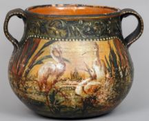 A 19th century French pottery jardiniere
Decorated in muted tones with storks in a landscape, the