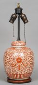 A Chinese porcelain ginger jar and cover
With allover iron red lotus strapwork decoration, on wooden