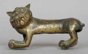An 18th/19th century Indian brass model of a grinning tailless feline
Modelled with protruding