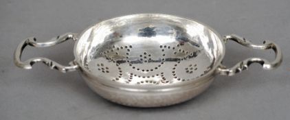 A George II silver lemon strainer, hallmarked London 1736, maker's mark of John Gamon
The pierced