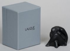 A boxed Lalique black glass model of a naked figure
Modelled with head between crossed knees. 6