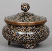 A fine late 19th century Japanese cloisonne bowl and cover
The three footed vessel with allover