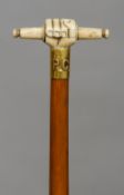 A 19th century bone handled bamboo walking stick
The handle formed as a clenched fist holding a