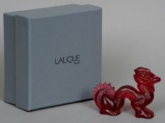 A boxed Lalique red glass model of a dragon
10 cms wide.   CONDITION REPORTS:  Overall good, some