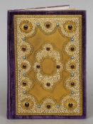 A 19th century gilt bronze blotter
Decorated with enamel C-scrolls and cabochon set stones.  24.5