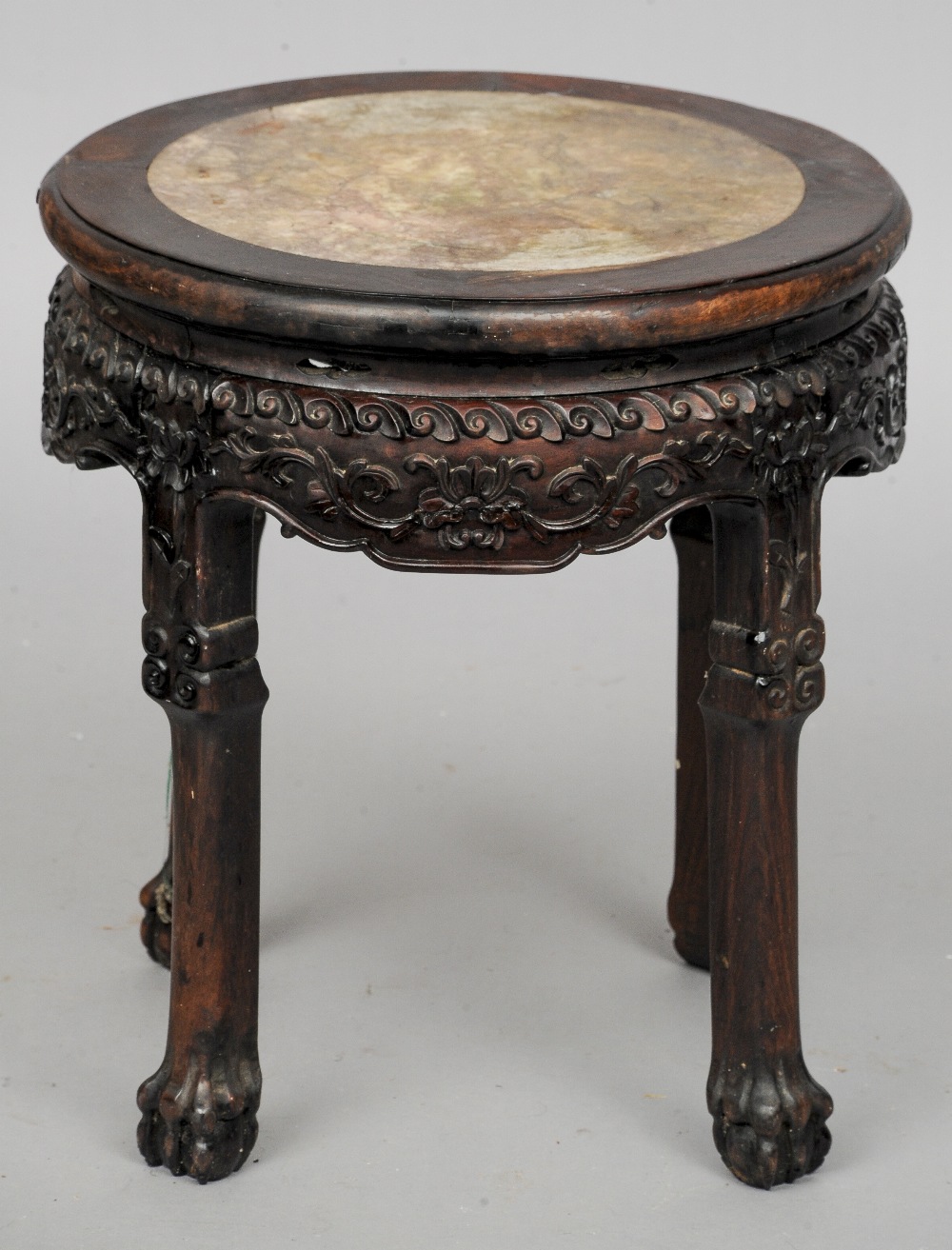 A 19th century Chinese marble inset carved hardwood side table
The circular top with inset marble