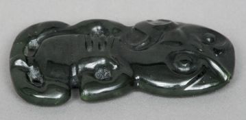 A Maori carved green stone (jade) Tiki pendant
Of typical form, with suspension hole.  7.5 cms long.