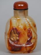 A Chinese carved agate snuff bottle
Worked with a pair of figures.  7.5 cms high.   CONDITION
