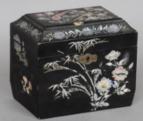 A 19th century Japanese mother-of-pearl inlaid lacquered tea caddy
Of sarcophagus form, inlaid