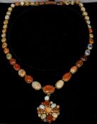 An unmarked gold pendant necklace
Variously set with diamonds, opals, moonstones and agate.  45