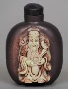 A Chinese carved stone or Zitao snuff bottle
Worked with the figure of a sage.  7.5 cms high.