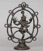 An Indian patinated bronze figure of Shiva as Nataraja in a circular mandala
21 cms high.