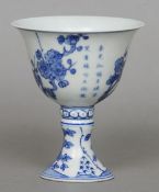 A Chinese fine porcelain blue and white stem cup
Decorated with flowering bamboo and calligraphy,