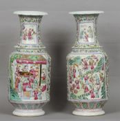 A pair of Chinese Canton porcelain vases
Decorated with figural vignettes on a floral ground with