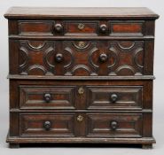 An 17th century oak chest of drawersThe moulded rectangular top above four geometrically moulded