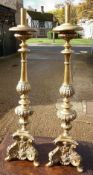 A pair of 19th century brass altar sticks
Of typical form with embossed decoration.  90 cms