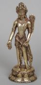 An Eastern silvered bronze model of a deity 
Modelled standing holding a flower and with turquoise