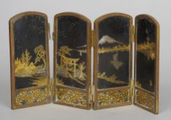 A Japanese Meiji bronze four fold Komai style table screen
Each panel worked in gold and silver,