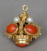 An unmarked gold pendant, possibly Indian, probably high carat gold
Set with seed pearls and coral