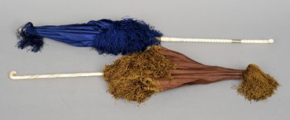 Two 19th century parasols
One in blue silk, the other brown, both with carved ivory handles.   The