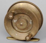 A brass centre pine reel with brass handles