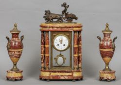 A bronze mounted red marble triple clock garniture
The case surmounted with the figure of a putti
