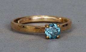 A 9 ct gold blue diamond solitaire ring
The claw set stone approximately 0.60 carat; together with