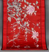 A Chinese silk work panel
Worked with a pierced rock issuing floral sprays incorporating four