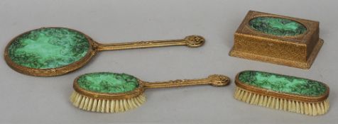 A Continental green glass inset gilt metal dressing set
Comprising: dressing mirror, two clothes