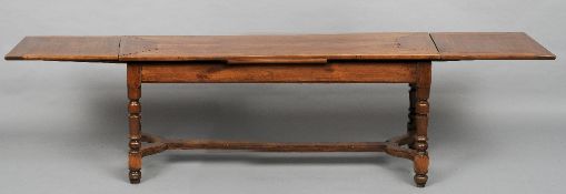 A 19th century cherrywood farmhouse drawer leaf table
The cleated rectangular top issuing twin