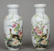 A small pair of Chinese porcelain famille rose vases
Each painted with a goose amongst foliage,