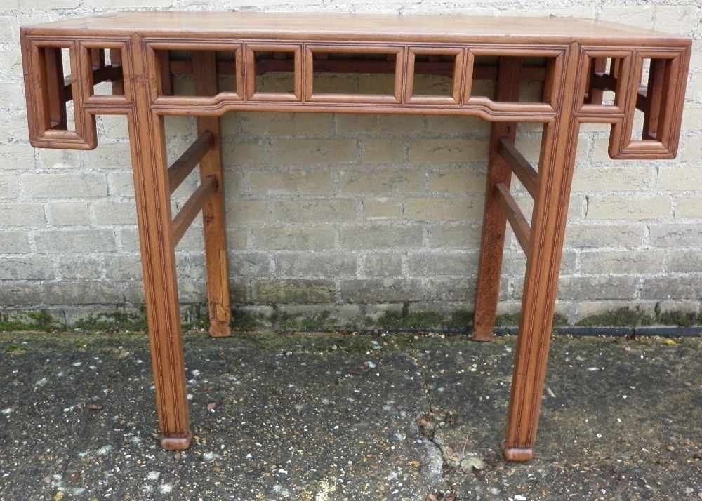 A 19th century Chinese elm altar table
The cleated rectangular top above a frieze of pierced