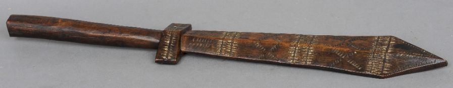 A 19th century war club, probably Samoan
The elongated handle above the chip carved hilt and blade.