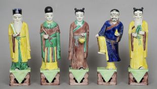 A set of five Chinese pottery figures
Each figure holding a different object and mounted on a