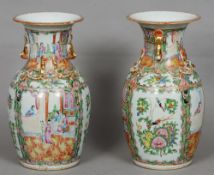 A pair of Cantonese porcelain famille rose vases
Each of flared baluster form with gilt heightened