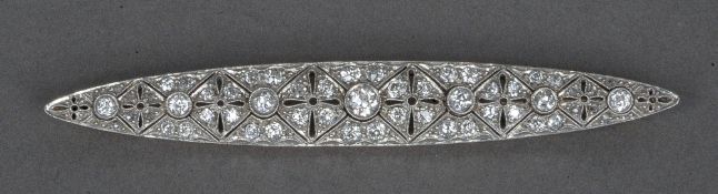 An Art Deco diamond set platinum and gold brooch
Of pierced navette form, set with approximately 2.