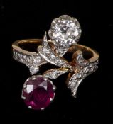 An unmarked gold, diamond and ruby ring
Of scrolling floral form, set with  1 carat ruby and a 0.5